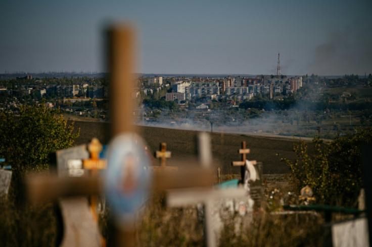 Smoke rises outside Bakhmut, where the conflict has exposed divided loyalties