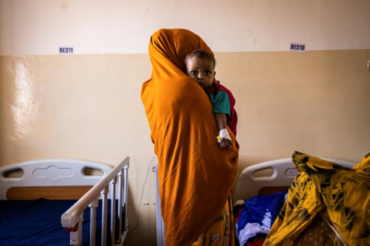 A mother holds her malnourished baby in Banadir Maternity and Children Hospital in Mogadishu, Somalia