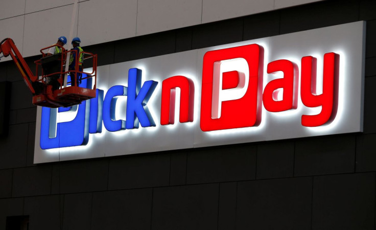 Workers repair a logo of South African retailer Pick n Pay in Johannesburg, South Africa, April 19,2018. 