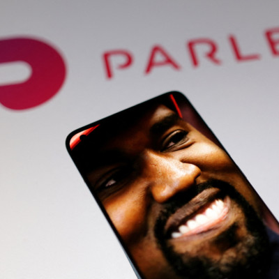 Illustration shows American rapper Kanye West's picture and Parler logo
