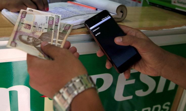 Customer conducts a mobile money transfer at a Safaricom agent stall in Nairobi