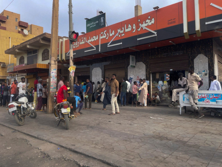 People gather to get bread in Khartoum