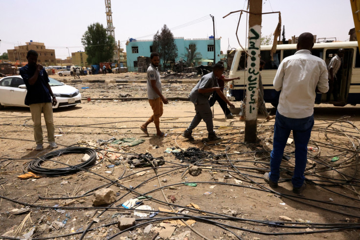 Electricity workers rehabilitate the power lines at the central market in Khartoum North