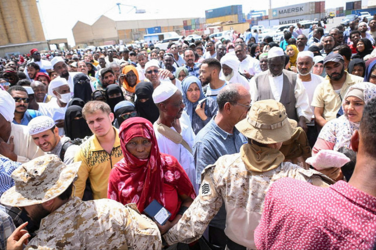 European, Asian and African nationals prepare to board a ship to Saudi Arabia, at Port Sudan