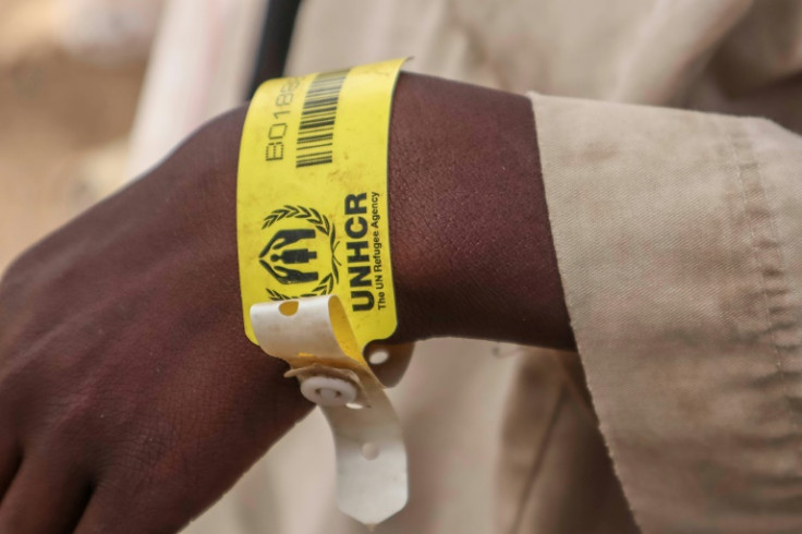 A Sudanese who has fled the conflict wears a wristband identification tag provided by the United Nations' refugee agency