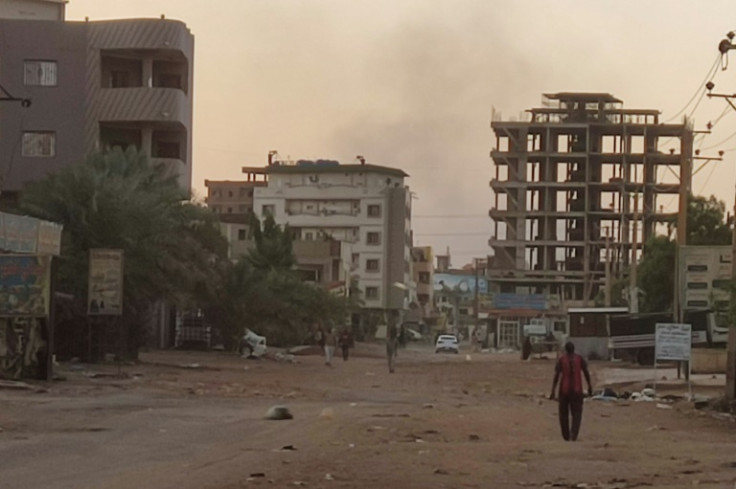 Few civilians venture out onto the near-deserted streets of the Sudanese capital