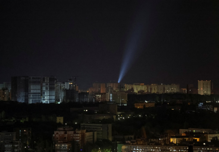 Ukrainian servicemen use searchlights as they search for drones in the sky over the city during a Russian drone strike in Kyiv