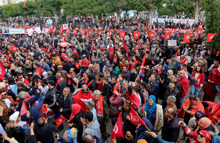 Supporters of Tunisia's President Kais Saied carry national flags
