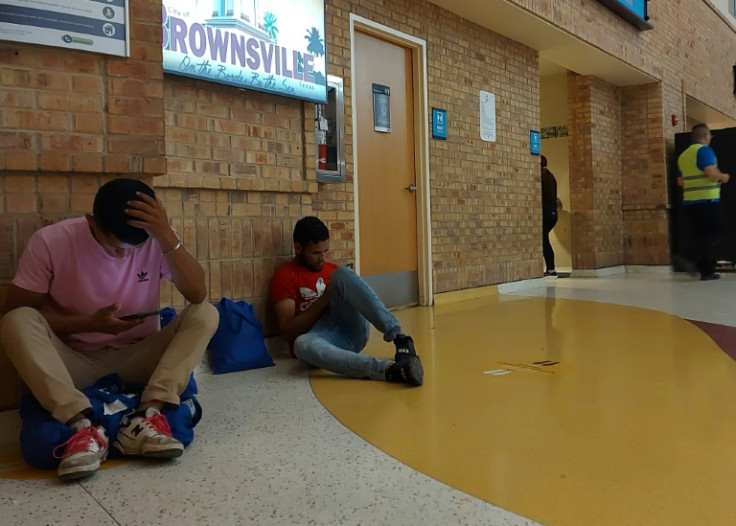 Migrants rest inside the bus terminal in Brownsville, Texas, on May 9, 2023