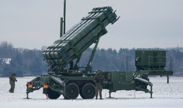 A soldier stands in front of a Patriot surface-to-air missile system during a military exercise in Poland on February 7, 2023