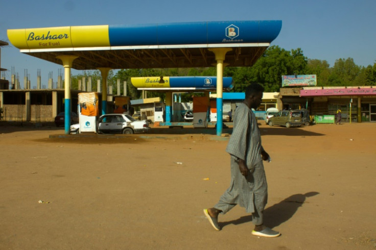 A man walks past a shuttered petrol station in Madani, southeast of the Sudanese capital Khartoum