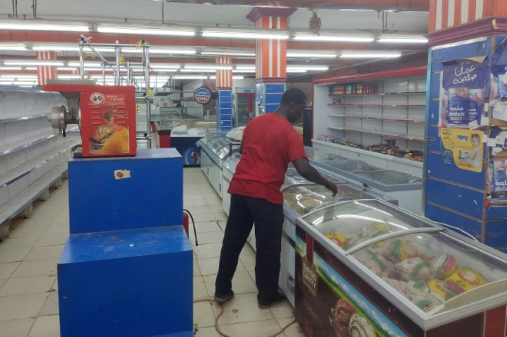A man walks past empty shelves at a supermarket in Khartoum on May 18
