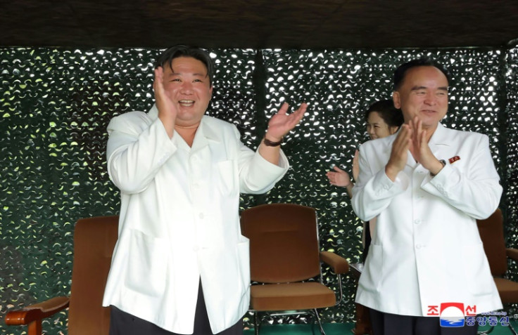 North Korean leader Kim Jong Un applauds during the test firing of the Hwasong-18 intercontinental ballistic missile