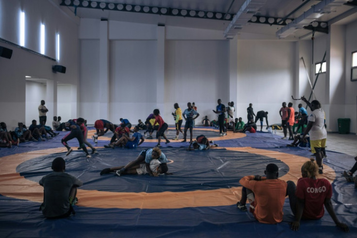 African wrestlers training at the Tata Raphael stadium as work pushes ahead to finish the venue before the July 28 opening ceremonies