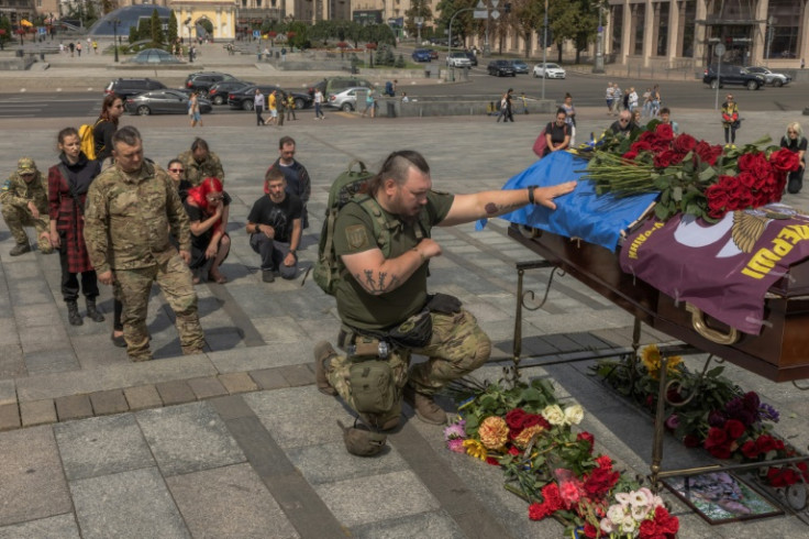 A Ukrainian serviceman pays his respects at the coffin of army combat medic Daria Filipieva