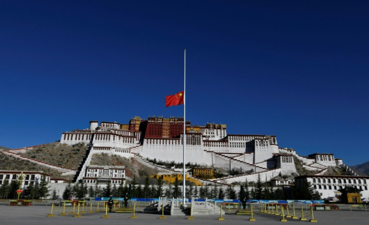 The Chinese national flag flies at half-mast for the passing of former Chinese leader Jiang Zemin in front of Tibet's historic Potala Palace in Lhasa on December 6, 2022