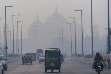 People commute along a street amid smoggy conditions in Lahore, Pakistan; South Asia is the global epicenter of an air pollution crisis, a scientific report says