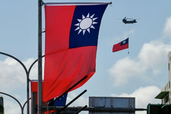 A CH-47 Chinook helicopter carries a Taiwan flag during national day celebrations in Taipei on October 10, 2021