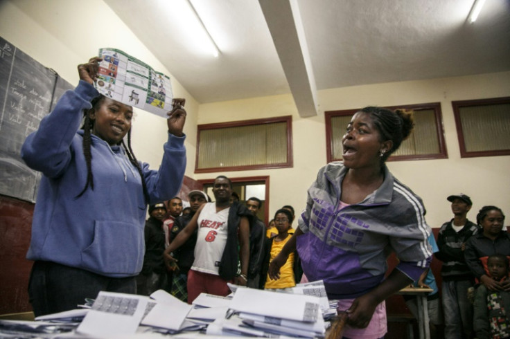 The count gets underway with an electoral official holding up a ballot paper