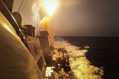 A handout picture courtesy of the US Navy shows the guided missile destroyer USS Carney firing on missiles and drones launched from Yemen on October 19, 2023