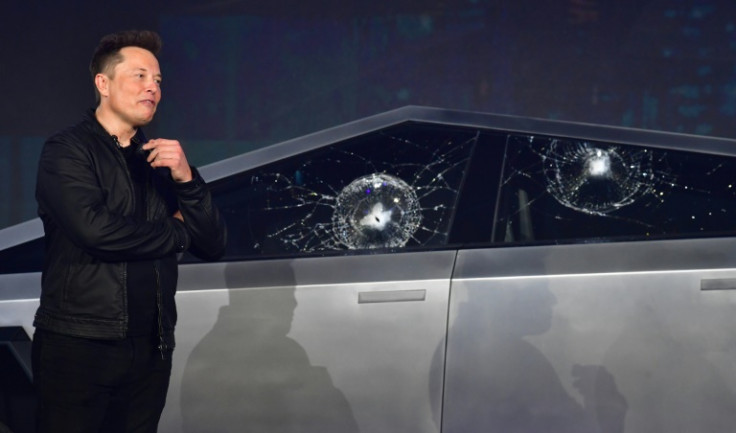 Tesla co-founder and CEO Elon Musk verbally reacts in front of the newly unveiled all-electric battery-powered Tesla Cybertruck with broken glass on windows following a demonstation that did not go as planned on November 21, 2019 at Tesla Design Center in