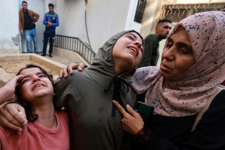 Family members mourn a baby girl killed in an Israeli strike in Rafah on December 1