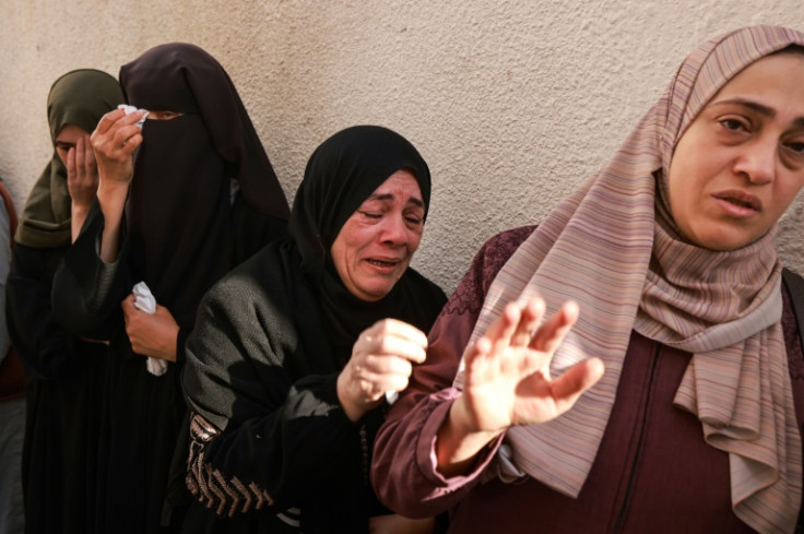 Women mourn relatives killed in Israeli air strikes on Rafah in the southern Gaza Strip on December 4, 2023