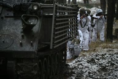 Ukrainian servicemen in snow camouflage take part in the Kharkiv region on December 1, 2023, amid the Russian invasion of Ukraine