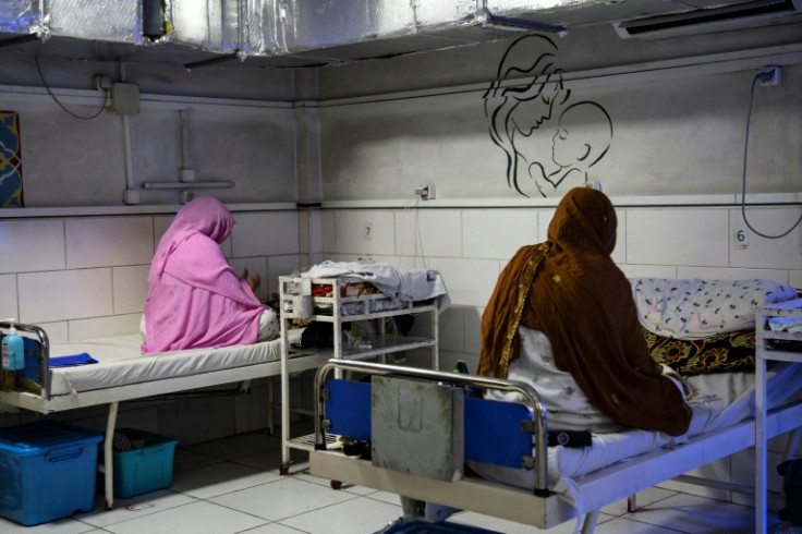 Afghan women sit beside their newborns at the Doctors Without Borders (MSF)-run maternity hospital in Khost