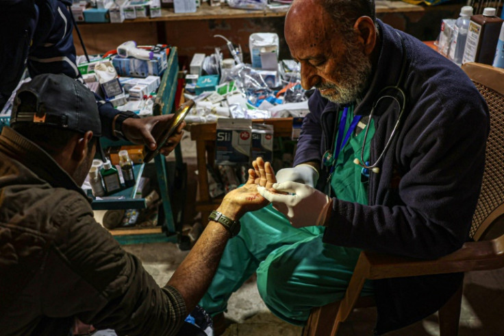 Zaki Shaheen treats a wounded man at his makeshift clinic in Rafah on Tuesday