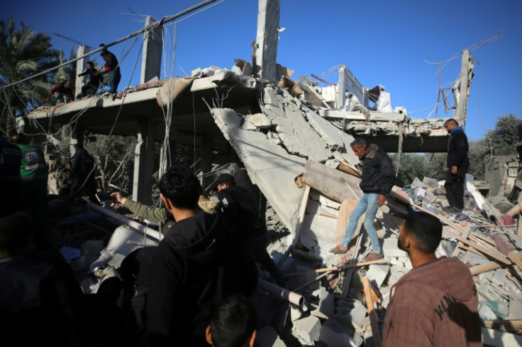 Palestinians inspect the rubble of a house in Deir al-Balah on Tuesday after an Israeli strike