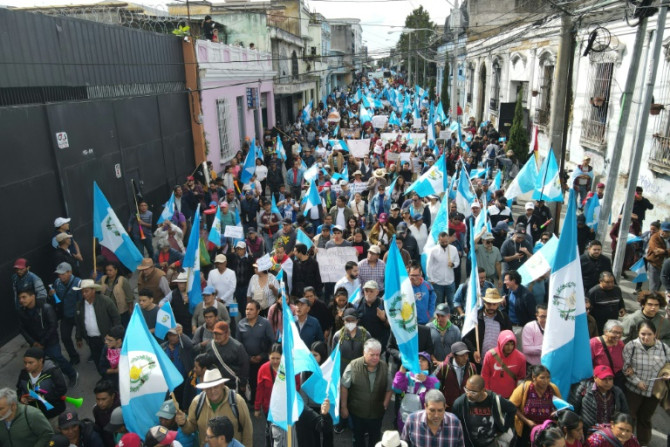 People take part in a "March for Democracy" in Guatemala City on December 7, 2023