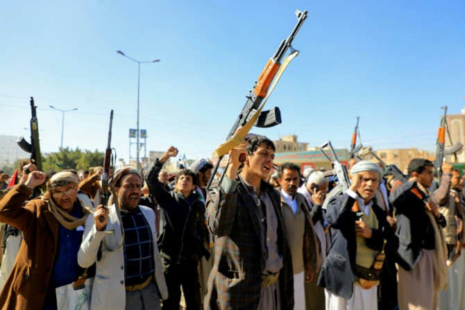 Huthi fighters brandish their weapons during a march in solidarity with the Palestinian people in Yemen's Huthi-controlled capital Sanaa on January 11, 2024