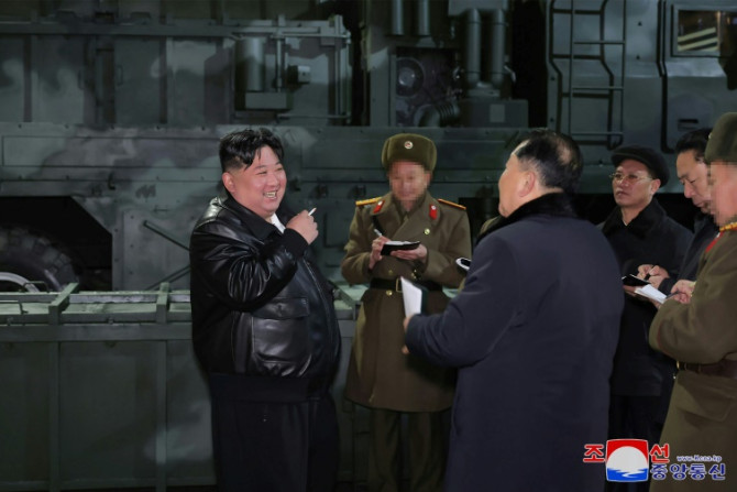 Kim Jong Un (L), seen inspecting a munitions factory, has called for constitutional changes allowing for South Korea's 'occupation' in event of war