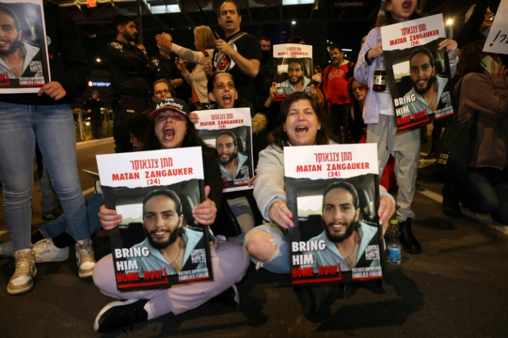 Freed Israeli former hostage Ilana Gritzewsky (seated L) joins relatives and supporters at a rally calling for the release of those still in Gaza
