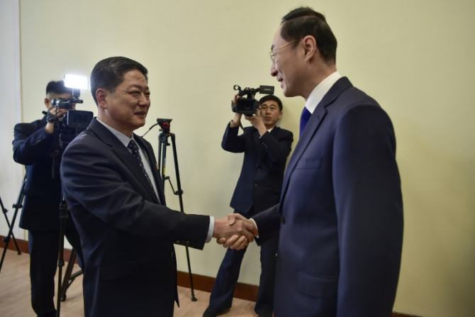 China's Vice Foreign Minister Sun Weidong (R) shakes hands with North Korea's Vice Foreign Minister Pak Myong Ho during a meeting at the People's Palace of Culture in Pyongyang