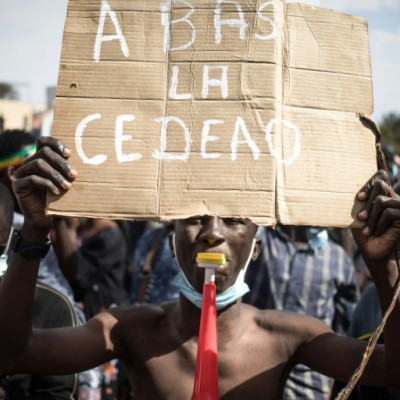 'Down with ECOWAS' says a placard at a January 2022 protest in Bamako against sanctions imposed on Mali by the West African bloc