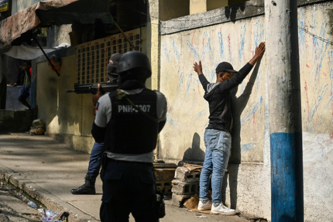Haitian police arrest a man in the Turgeau commune of Port-au-Prince during gang-related violence in April 2023