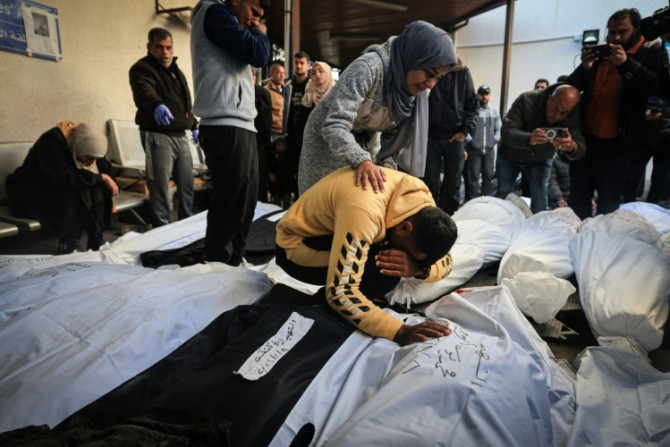Palestinians mourn over shrouded bodies of relatives killed in overnight Israeli bombardment on the southern Gaza Strip at Al-Najjar hospital in Rafah on February 8, 2024