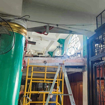 A balcony partially collapsed inside a church in San Jose del Monte, near Manila, on Wednesday