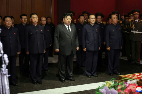 Leader Kim Jong Un (C) and senior officials pay their respects to North Korea's former propaganda chief Kim Ki Nam, who died on Tuesday at the age of 94, KCNA reported