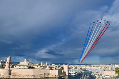 The French Air Force display team  sprays the colours of the French flag above Marseille's Old Port as the Olympic flame arrives