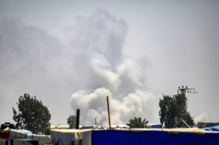Smoke plumes billow near tents sheltering displaced Palestinians in Rafah in the southern Gaza Strip on June 4, 2024