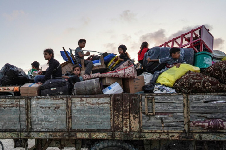 Displaced Palestinians leave an area in east Khan Yunis after the latest Israeli evacuation order