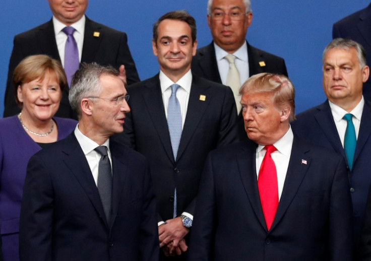 NATO Secretary-General Jens Stoltenberg exchanges a word with US President Donald Trump as fellow NATO leaders look on during a summit in Watford, England in December 2019