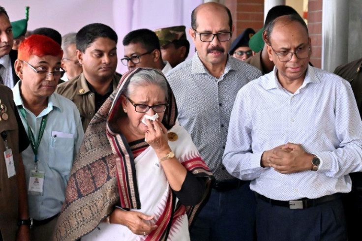 Prime Minister Sheikh Hasina (C) weeps while visiting a metro station in Mirpur vandalised during students-led protests against a jobs quota system