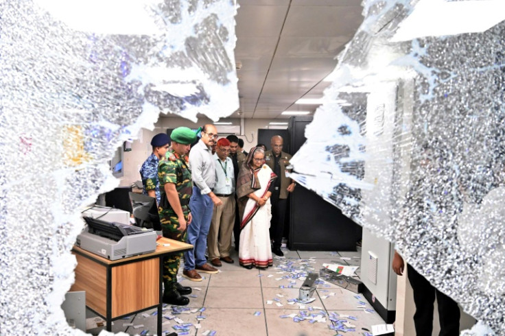 Bangladesh Prime Minister Sheikh Hasina (2R) visits a metro station vandalised during protests against a government jobs quota system