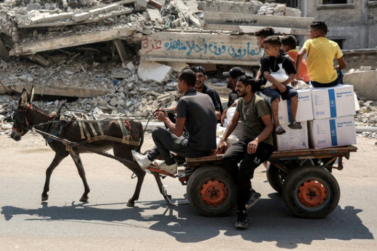 Gazans ride a donkey-drawn cart carrying boxes of aid in Gaza City