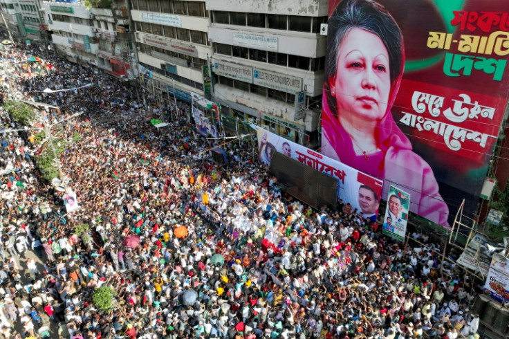 Bangladesh Nationalist Party activists gather in front of a poster of Khaleda Zia, during a rally in Dhaka two days after ex-premier Sheikh Hasina's ouster