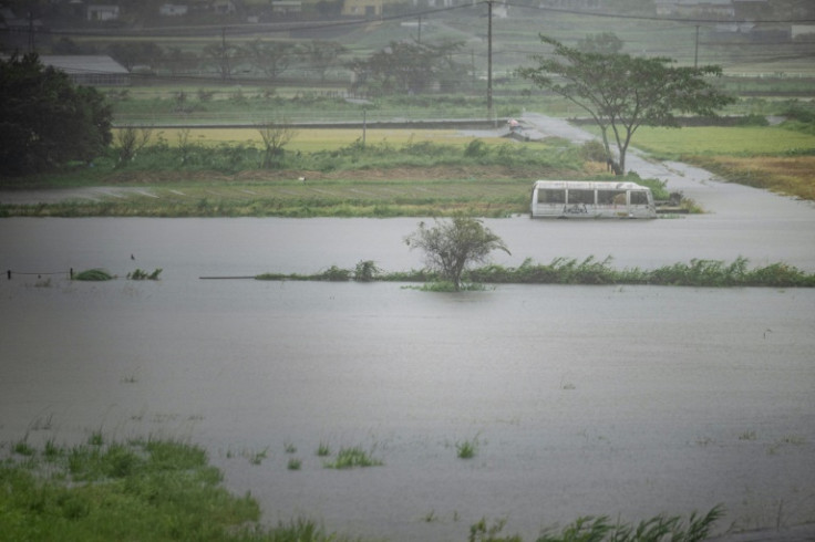 A bus is seen submerged in floodwaters in Yufu city of Oita prefecture